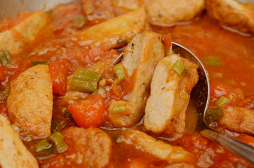 Fried fishcakes slices with tomato sauce