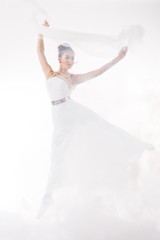 Fototapeta na wymiar Ballerina jump in the clouds
