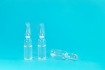 Ampoule on a blue background with close-up. COVID-2019