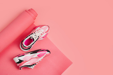 Pink sneakers on yoga mat. Healthy lifestyle. Fashion blog or magazine concept.  Flat lay top view copy