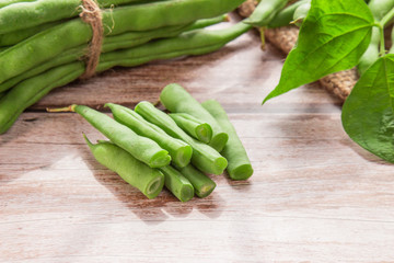 Green beans close up on wooden background