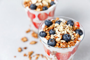 Granola parfait with greek yogurt, oat cereal, fresh berries, honey in glass jar