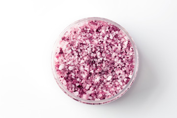 Pink sea salt with Argania in a jar isolated on a white background. Top view.
