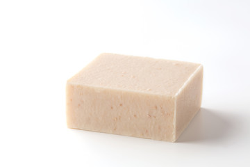 Natural soap scrub with milk, oatmeal and honey on a white background.