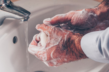 Washing hands rubbing with soap man for corona virus prevention, hygiene to stop spreading coronavirus.