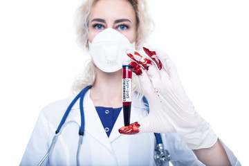 The doctor in bloodied gloves holds a test tube with blood