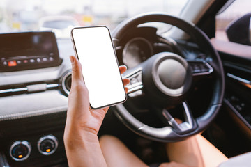 Women holds a smartphone with mockup in the car.