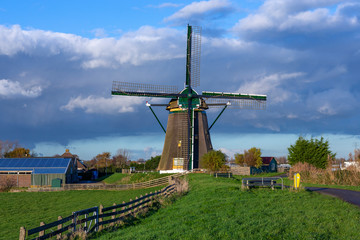 The historic Lisserpoel windmill build in 1676. Along the river the Ringvaart. On the Rooversbroekdijk in the Hellegatspolder in the Netherlands.