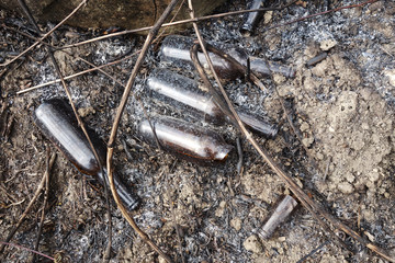 Glass bottles in ash after fire