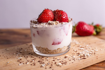 Yogurt with oat, strawberries, chocolate and almonds. Healthy and nutritious snack. Oatmeal yogurt, good protein food for muscles.Yogurt with oat, strawberries, chocolate and almonds. Healthy and nutr
