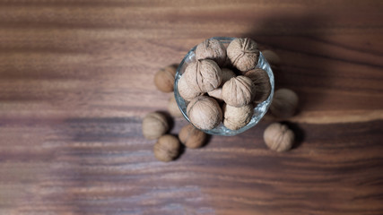 walnut in a glass vase on a wooden background