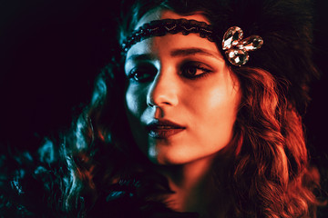 Portrait of vintage styled red haired woman dressed in Great Gatsby era flirting and posing on...