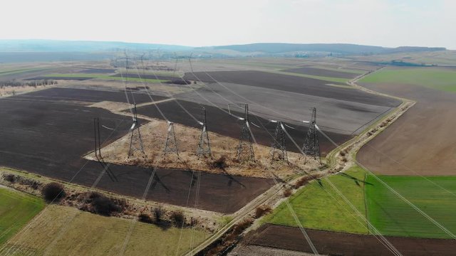 Aerial view Long distance transmission lines. High-voltage pillars that energy efficiently deliver thousands of kilovolts of electricity between cities. High voltage stepping.