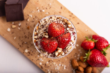 Yogurt with oat, strawberries, chocolate and almonds. Healthy and nutritious snack. Oatmeal yogurt, good protein food for muscles.