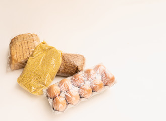 food donation. Buckwheat, eggs, bread and millet on a white background
