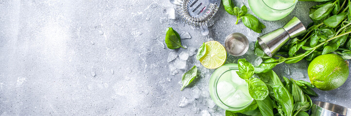 Basil smash gin alcoholic cocktail. Long alcohol drink recipe with fresh basil leaves and limes,...