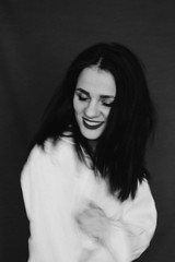 Black and white portrait of laughing and smiling girl with blur