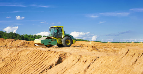 Obraz premium soil compactor on road construction site