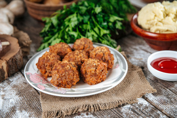 Side view on appetizing cooked homemade meatballs with meat, rice and vegetables, tefteli, with mashed potatoe, red sauce and garlic, horizontal