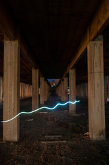 Man rotating a steel wool on fire in an abandoned building