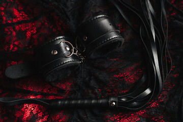Leather handcuffs and whip for BDSM role-playing sex games