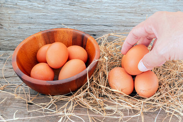 Men's hand collecting freshly laid eggs., Eggs are ready for cooking