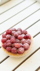 cupcake with fresh raspberries and powdered sugar close up 