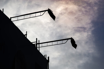 Silhouette of spotlights and large billboards