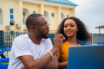 two african couple having a nice time in a park feeling happy a