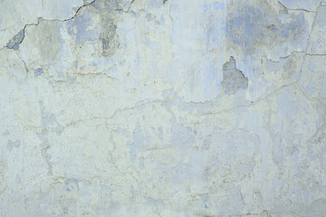 The old plastered wall with a blue shade background