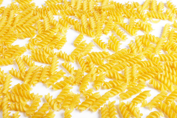 raw fusilli pasta on a white background.