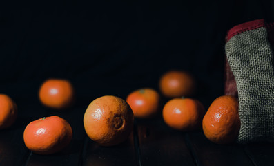 Fresh and ripe mandarins (tangerines, clementine) on black background
