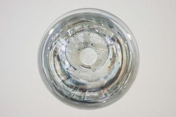 The interior design element of a huge store is the original form of transparent round glass ball-lamps of silver color.