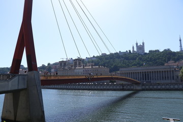 The picture of a huge suspension bridge in the middle of a large city.