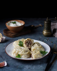Manta rays with meat filling on a plate. One is cut.