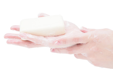 Soap hands holding a bar of soap, close-up, isolate on a white background. Antibacterial disinfectant soap as a means of protection against microbes during the coronavirus and flu pandemic