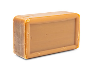 A piece of brown soap, isolate on a white background, close-up. Mockup, a place for your label. Soap as a means of hygiene and a way to protect against germs. Tar antibacterial baby soap