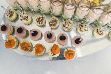 A lot of sandwiches with fish, cheese and meat close-up.
