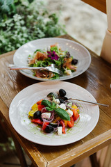 Greek salad on a table in a cafe on the terrace.