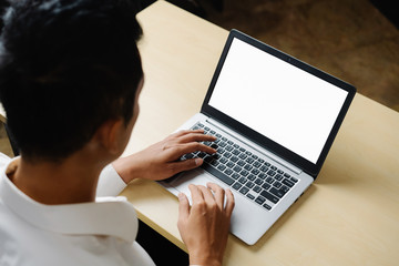 Business person or office worker using laptop computer while sitting at desk.