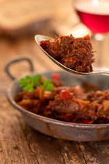portion of austrian goulash on wood