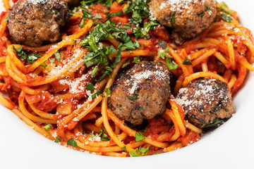 spaghetti with meat balls on dark wood