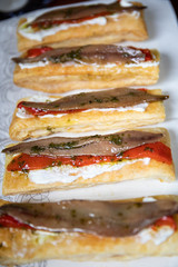 Anchovy toast with red pepper and white cheese