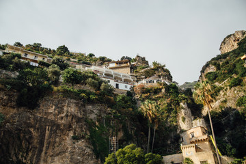 Fototapeta na wymiar Houses and hotels are built on rocks in Positano and Italy