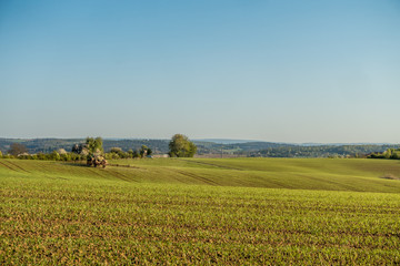 Traktor beim d&uuml;ngen auf dem Feld