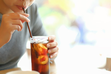 closeup woman drinking ice cola in the glass.food and beverage concept.