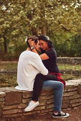 Fototapeta premium Couple in love hugging and kissing outdoors. Love concept.