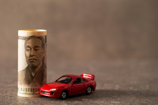 Japanese bills and toy cars
