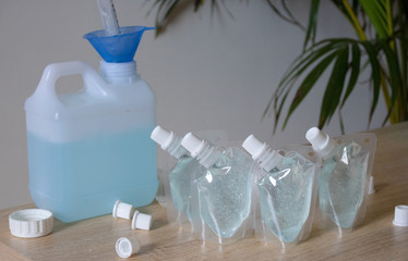 Add alcohol gel from the gallon bucket to the alcohol gel sachet bag. On the table and the white...