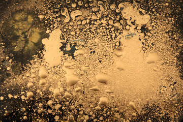 Macro black and gold Abstract bubble drop texture background. Acrylic color in water and oil.